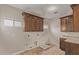 Laundry room with wood cabinets and tile flooring at 8611 E Cholla St, Scottsdale, AZ 85260