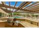 Outdoor kitchen with built-in grill, granite counters, and pergola at 8611 E Cholla St, Scottsdale, AZ 85260