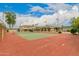 Private tennis court with red clay surface at 8611 E Cholla St, Scottsdale, AZ 85260