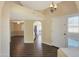 Bright entryway with wood flooring, offering a view of the kitchen and living areas at 11845 N 40Th Pl, Phoenix, AZ 85028