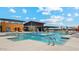 Large community pool with multiple areas, fountains and lounge chairs at 12078 E Aster Ln, Florence, AZ 85132