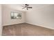 Bright bedroom featuring a ceiling fan and window at 13311 W Castle Rock Dr, Sun City West, AZ 85375