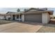 Remodeled single-story home with gray garage door and new landscaping at 13311 W Castle Rock Dr, Sun City West, AZ 85375