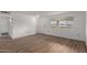 Living room with wood-look flooring and white walls; door and window visible at 14248 N Sarabande Way, Sun City, AZ 85351