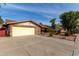 House exterior with a yellow garage door and landscaped front yard at 1626 E Garnet Ave, Mesa, AZ 85204