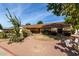 Landscaped front yard with desert plants and a fire pit at 1626 E Garnet Ave, Mesa, AZ 85204