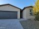 Modern single story home with a two car garage and stone driveway at 18128 N Bell Pointe Blvd, Surprise, AZ 85374