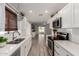 Modern kitchen with white shaker cabinets, quartz countertops and stainless steel appliances at 18607 N 125Th Ave, Sun City West, AZ 85375