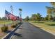 Landscaped road with American flags, leading to golf course at 1891 E Kerby Farms Rd, Chandler, AZ 85249