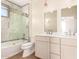 Modern bathroom with double vanity, marble tile, and glass shower at 2012 W Lawrence Rd, Phoenix, AZ 85015