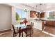 Dining area adjacent to the kitchen with glass-top table and wood chairs at 2012 W Lawrence Rd, Phoenix, AZ 85015