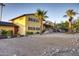 Bright yellow two-story home with desert landscaping at 2034 E Glendale Ave, Phoenix, AZ 85020