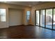 Spacious living room with wood-look tile flooring and access to backyard at 21024 E Poco Calle St, Queen Creek, AZ 85142