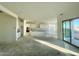 Open-plan kitchen and living area with white cabinetry and large windows at 22874 E Alyssa Rd, Queen Creek, AZ 85142