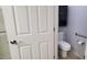 View of a toilet, wall cabinet, and grab bars in a bathroom at 2630 E San Mateo Dr, Casa Grande, AZ 85194