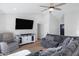 Living room with hardwood floors, sectional sofa, and large TV at 309 W Ross Ave, Phoenix, AZ 85027