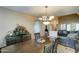 Bright dining room features a large table, chandelier, and view into the living room at 3444 E Melody Dr, Phoenix, AZ 85042