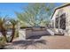 Built-in outdoor kitchen with a grill and stone countertops at 3701 E Sat Nam Way, Cave Creek, AZ 85331
