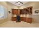 Spacious home office with built-in corner desk and shelving at 3701 E Sat Nam Way, Cave Creek, AZ 85331