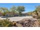 Landscaped backyard with a large pool and rock waterfall feature at 3701 E Sat Nam Way, Cave Creek, AZ 85331