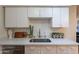 Modern kitchen with stainless steel sink and white cabinetry at 611 W Hononegh Dr # 2, Phoenix, AZ 85027