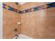 Shower/tub combo with colorful tile and fixtures at 611 W Hononegh Dr # 2, Phoenix, AZ 85027