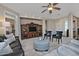 Spacious living room with leather sofas, a large TV, and a comfy ottoman at 6710 W Sandpiper Way, Florence, AZ 85132