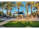 Community pool with shade structures and palm trees at 6710 W Sandpiper Way, Florence, AZ 85132