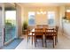 Dining area with a wooden table and access to a patio at 6842 S Santa Rita Way, Chandler, AZ 85249