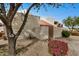 Tan stucco exterior with a tiled roof and a wooden gate at 8867 N 48Th Dr, Glendale, AZ 85302