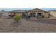 Backyard with patio, gravel, and mature shrubs at 9930 W Concord Ave, Sun City, AZ 85351