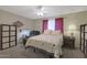 Charming bedroom with a comfortable bed, dresser, and ceiling fan at 9930 W Concord Ave, Sun City, AZ 85351