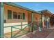 Front porch with green railing and brick accents at 9930 W Concord Ave, Sun City, AZ 85351