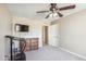 Well-lit bedroom with ceiling fan, dresser, and wall-mounted TV at 1045 E Cloud Rd, Phoenix, AZ 85086