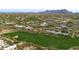 Golf course community with lake and luxury homes; mountain backdrop at 10542 E Skinner Dr, Scottsdale, AZ 85262