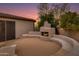 Relaxing backyard patio with fire pit and seating area, perfect for outdoor entertaining at 10542 E Skinner Dr, Scottsdale, AZ 85262