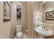 Elegant powder room with pedestal sink and frameless mirror at 10542 E Skinner Dr, Scottsdale, AZ 85262