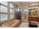 Spa-like bathroom with soaking tub, walk-in shower, and double vanity at 10542 E Skinner Dr, Scottsdale, AZ 85262