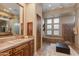 Elegant bathroom with soaking tub, double sinks, and a large mirror at 10542 E Skinner Dr, Scottsdale, AZ 85262