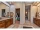 Bathroom with double vanities, large walk-in closet, and sitting area at 10542 E Skinner Dr, Scottsdale, AZ 85262