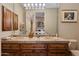 Double vanity bathroom with a large mirror and beige tile at 10542 E Skinner Dr, Scottsdale, AZ 85262