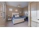 Bright bedroom with a queen-size bed, tan walls, and large windows at 10542 E Skinner Dr, Scottsdale, AZ 85262