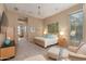 Bright bedroom with a king-size bed, ensuite bathroom access, and sitting area at 10542 E Skinner Dr, Scottsdale, AZ 85262