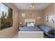 Guest bedroom with a queen bed, a tanning bed, and desert views at 10542 E Skinner Dr, Scottsdale, AZ 85262