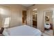 Bedroom with a full-size bed, mirrored closet doors, and en-suite bathroom at 10542 E Skinner Dr, Scottsdale, AZ 85262