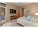 Spacious bedroom with large TV, comfortable seating, and access to a private balcony at 10542 E Skinner Dr, Scottsdale, AZ 85262