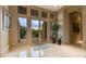 Bright entryway with tiled floors, double doors, and views of the desert landscape at 10542 E Skinner Dr, Scottsdale, AZ 85262
