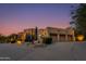 Three-car garage with desert landscaping at 10542 E Skinner Dr, Scottsdale, AZ 85262