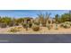 Luxury home with desert landscaping and a welcoming front entrance at 10542 E Skinner Dr, Scottsdale, AZ 85262