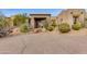 Front entrance of the house with desert landscaping and a long driveway at 10542 E Skinner Dr, Scottsdale, AZ 85262